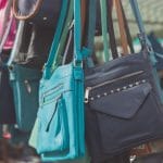 37672195 – colorful handbags hanging in a stall at a market