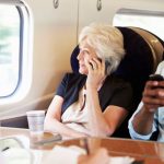 28159443 – businesswoman using mobile phone on busy commuter train