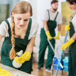 54189995 – young pretty cleaning girl in uniform polishing the marble table