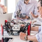 79317832 – group of inventors constructing devices in office
