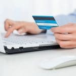 35001455 – close up of female hands making online payment