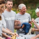 44775464 – happy volunteer looking at donation box on a sunny day