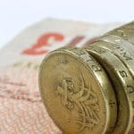 37230987 – one pound coins on the edge on a white background