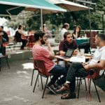 young people working on laptops in a bar
