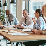 Smiling group of diverse businesspeople meeting together in an o