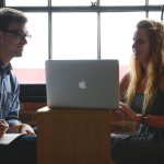 Man and woman working on a laptop