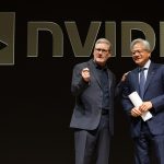 Two men stand on stage in front of NVIDIA logo.