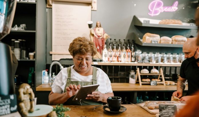 older woman business owner cafe on tablet older woman business owner cafe on tablet