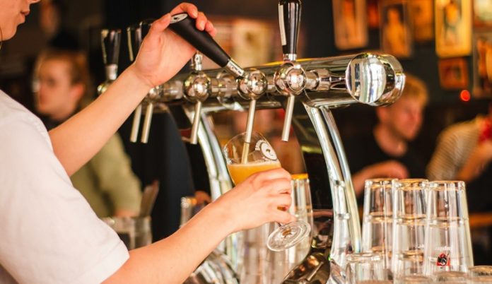 beer being poured in pub